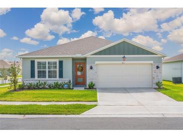 Charming single-story home features a well-maintained lawn and a two-car garage at 401 Chayne Pl, St Cloud, FL 34771