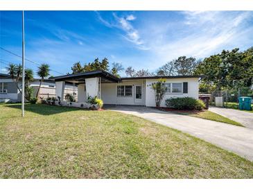 Charming single-story home with a well-manicured lawn and inviting covered entryway at 5438 San Luis Dr, Orlando, FL 32807