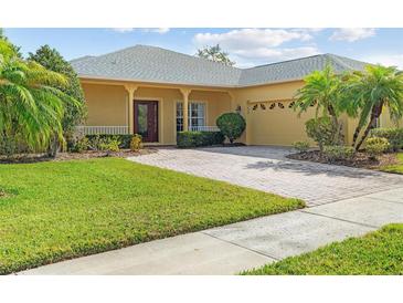 Charming single-story home with a brick driveway, mature landscaping, and a welcoming front porch at 663 Shorehaven Dr, Poinciana, FL 34759