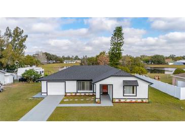 Charming single-story home featuring a well-maintained lawn and neutral color scheme at 83 Alameda Dr, Kissimmee, FL 34743