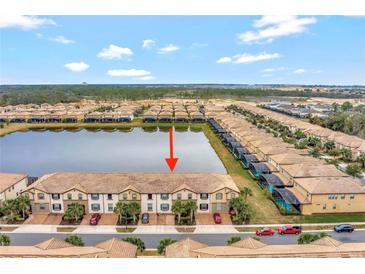 Aerial view of townhouses with lake access at 8886 Geneve Ct, Kissimmee, FL 34747