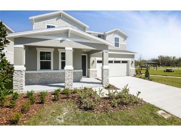 Beautiful two-story home featuring a well-manicured lawn and a two-car garage on a sunny day at 1509 August Gray Dr, Kissimmee, FL 34744