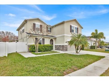 Charming two-story home with a well-maintained lawn and beautiful landscaping at 2849 Shelburne Way, St Cloud, FL 34772