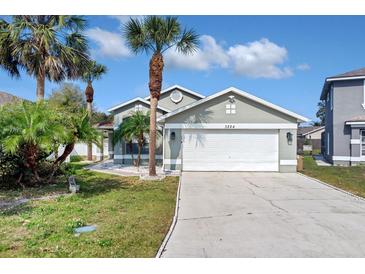 Charming one-story house with a two-car garage and landscaped front yard at 3224 Fairfield Dr, Kissimmee, FL 34743