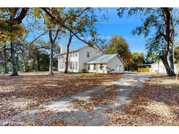 Charming two-story home with a long driveway and mature trees at 4855 Lillian Black Rd, St Cloud, FL 34771