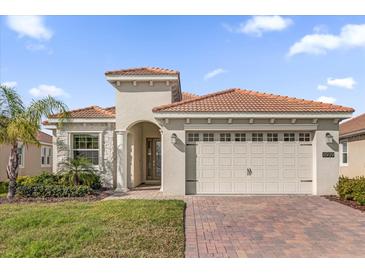 Charming single-Gathering home featuring a well-manicured lawn and a tile roof at 8939 Fallen Oak Dr, Davenport, FL 33896