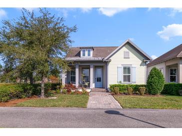 Charming single-story home with a well-manicured lawn and a welcoming front porch under a partly cloudy sky at 13432 Beebe Aly, Orlando, FL 32827