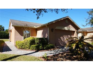 Charming single-story home with a well-maintained front yard and a two-car garage at 156 Grand Canal Dr, Poinciana, FL 34759