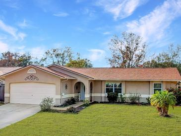 Charming single-story home with well-manicured lawn and a two-car garage at 206 Memphis Pl, St Cloud, FL 34769
