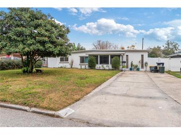 Charming single-story home with well-maintained lawn and a long driveway at 4126 Montrose Ct, Orlando, FL 32812