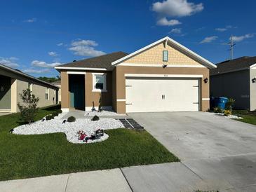 Charming one story home with a well manicured lawn and a two car garage at 735 Chinoy Rd, Davenport, FL 33837