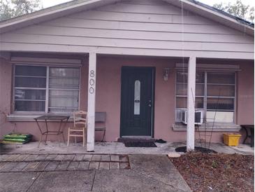 Modest home exterior with a covered front porch and some outdoor seating at 800 Nicole Blvd, Ocoee, FL 34761