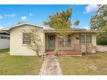 Charming single-story home featuring a brick walkway and cozy front porch at 900 Delaware Ave, St Cloud, FL 34769