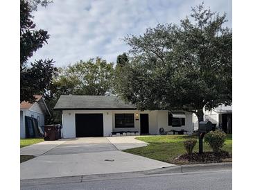 Charming single-story home with a well-maintained front yard and attached garage at 332 Carolina Ave, St Cloud, FL 34769