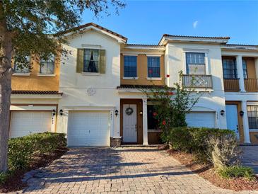 Charming two-story townhouse with brick paved driveway and well-manicured landscaping at 3491 Allegra Cir, St Cloud, FL 34772