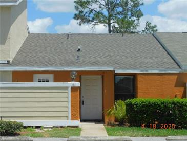 Inviting townhome featuring a well-kept lawn and a cozy front entrance, perfect for a starter home at 84 Silver Park Cir, Kissimmee, FL 34743