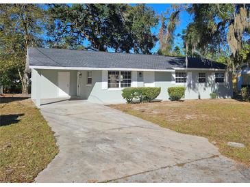 Charming single-story home with a well-maintained lawn and a concrete driveway at 2209 Sw 6Th St, Ocala, FL 34471