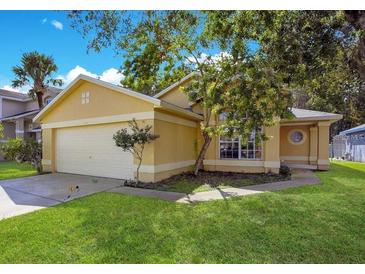 Charming single-Gathering home featuring a well-maintained lawn and two-car garage at 3048 Stillwater Dr, Kissimmee, FL 34743