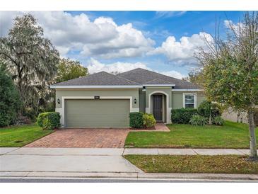 Charming single-story home featuring a two-car garage and a well-manicured lawn with mature landscaping at 3204 Wauseon Dr, St Cloud, FL 34772