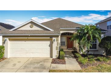 Charming single-story home featuring a two-car garage, neatly landscaped front yard, and a welcoming entryway at 331 Henley Cir, Davenport, FL 33896