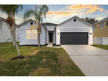 Charming single-story home featuring a well-maintained lawn and a two-car garage at 3431 Perching Rd, St Cloud, FL 34772