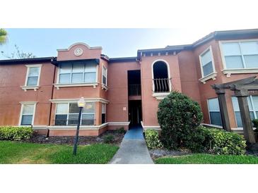 Beautiful two-story condo with well-maintained landscaping and a welcoming entrance at 5116 Conroy Rd # 12, Orlando, FL 32811