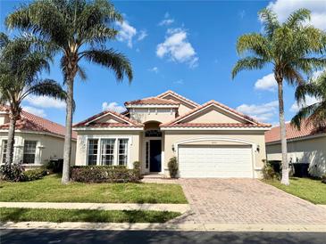 Charming single-story home with a tile roof, lush landscaping, and a two-car garage at 650 Tuscan Hills Blvd, Davenport, FL 33897