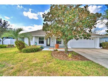 Charming single story home with well-manicured lawn and garden at 105 Shaddock Dr, Auburndale, FL 33823