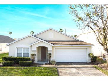 Charming single-story home featuring a well-maintained lawn, inviting entrance, and a convenient two-car garage at 226 Bailey Cir, Davenport, FL 33897