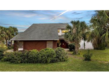 Two-story home with an attached two car garage and mature landscaping at 2462 Albany Dr, Kissimmee, FL 34758