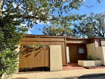 Charming exterior of home featuring well-maintained landscaping and a warm, inviting entrance at 2464 Harbour Way, Winter Park, FL 32792