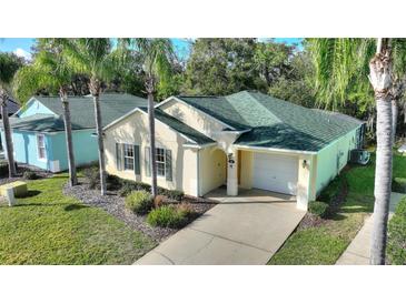 Charming single Gathering home features a well manicured lawn and an attached two car garage at 446 Reserve Dr, Davenport, FL 33896