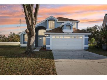 Charming two-story home with a well-maintained lawn and beautiful landscaping at 4919 Dunmore Ln, Kissimmee, FL 34746