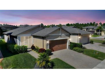 Charming single-Gathering home with lush landscaping, paver driveway, and two-car garage at 507 Pamplona Pl, Davenport, FL 33837