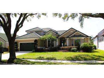 Charming one-story home features lush landscaping, a well-manicured lawn, and a tile roof at 7670 Milano Dr, Orlando, FL 32835