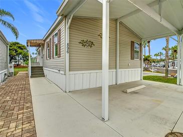 Charming home exterior featuring a carport and landscaped walkway in a well-maintained community at 9000 Us Highway 192 # 896, Clermont, FL 34714