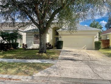 Charming single-Gathering home featuring a two-car garage and mature landscaping at 1137 Cherry Valley Way, Orlando, FL 32828