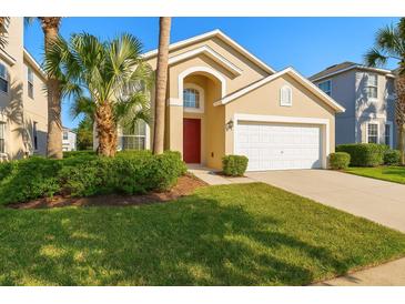 Charming single-Gathering home with a well-manicured lawn, lush landscaping, and an attached two-car garage at 8595 Sunrise Key Dr, Kissimmee, FL 34747