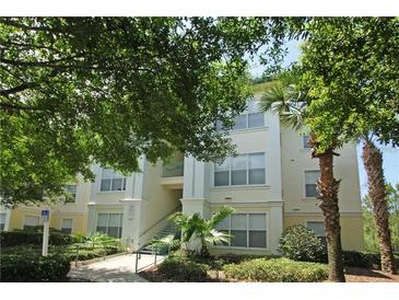 Condominium building featuring lush landscaping, multiple levels and well maintained common areas at 8927 Legacy Ct # 302, Kissimmee, FL 34747
