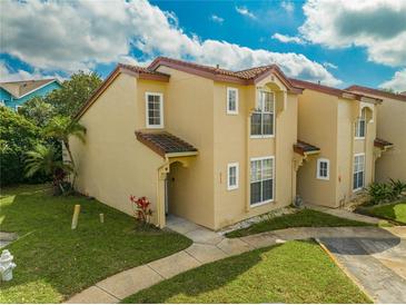 Charming two-story condo with a well-maintained lawn and a classic tiled roof at 8708 Papaya Dr, Kissimmee, FL 34747