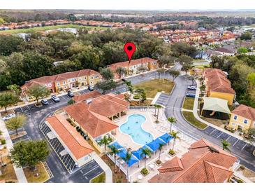 Aerial view of community featuring a swimming pool, playground, and manicured landscaping at 1007 Park Ridge Cir, Kissimmee, FL 34746