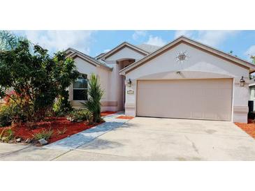 Charming single-story home with a two-car garage and beautifully landscaped front yard at 12634 Ringwood Ave, Orlando, FL 32837