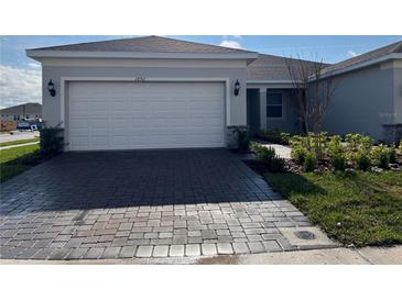 Charming single-Gathering home with a two-car garage and a brick-paved driveway at 1892 Spring Shower Cir, Kissimmee, FL 34744