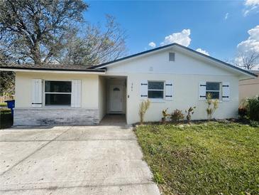 Charming single-story home featuring a well-maintained lawn, white shutters, and a welcoming front entrance at 301 Montana Ave, St Cloud, FL 34769