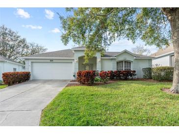 Charming single-story home with well-manicured lawn, complemented by vibrant shrubs and a two-car garage at 4086 Kingsley St, Clermont, FL 34711