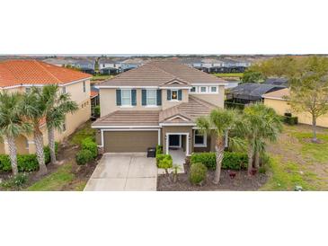 Charming two-story home with well-maintained landscaping and a two-car garage at 5411 Oakgrain Ct, Davenport, FL 33837