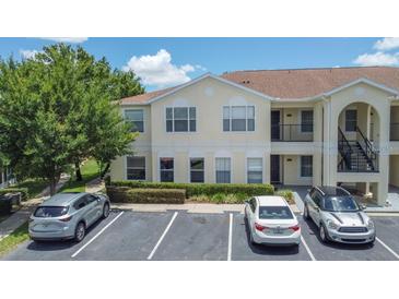 Inviting condo complex featuring well-manicured landscaping and convenient parking at 8824 Grand Palms Cir # A, Kissimmee, FL 34747