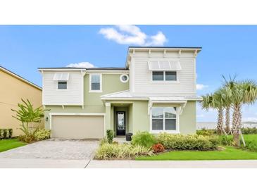 Charming two-story home with manicured landscaping and a welcoming entrance at 8962 Hilton Ridge Ave, Kissimmee, FL 34747