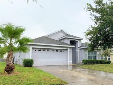 Charming single Gathering home with a two car garage and well maintained landscaping at 119 Southampton Dr, Kissimmee, FL 34744