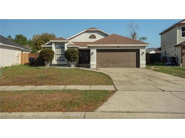 Charming single-Gathering home with a well-maintained lawn and two-car garage at 233 River Chase Dr, Orlando, FL 32807